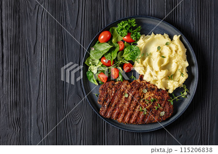grilled pork steak with mashed potato and salad 115206838