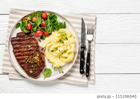 grilled pork steak with mashed potato and salad 115206840
