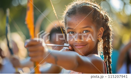 Young black girl engaging in a mock archery competition, with bows and arrows. Summer Olympic Games 115207941