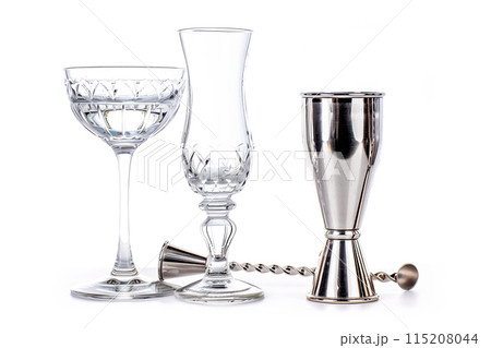 Bartender Stainless steel jigger, bar spoon and glasses isolated on white background 115208044