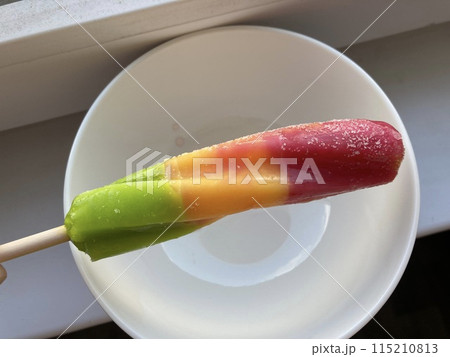 Multicolored sweet ice cream on a stick 115210813