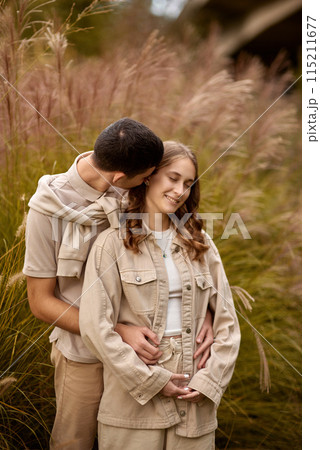 Happy couple on autumn walk outdoors. Two lovers in autumn park. Love and tender touch. Gentle hugs. Young man and woman in classic autumn colors outfit on a romantic date in a cozy park. Young girl 115211677