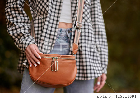 Autumn Elegance: Girl with Warm Tones, Casual Style, and a Park Stroll. Autumn Woman Portrait. Beauty Fashion Model Girl with Autumnal Make up and Hair style. Fall. Creative Autumn Makeup. Beautiful 115211691