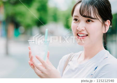 屋外で水を飲む若い女性 屋外で水を飲む若い女性 115212540