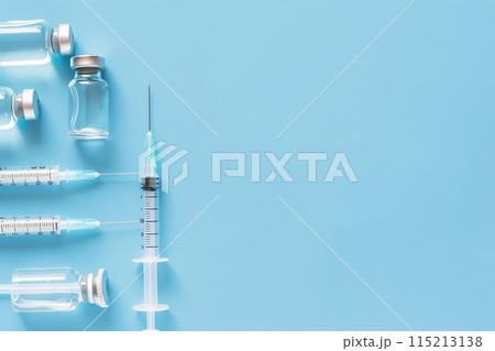 Syringe and glass vial on blue background flat lay. Medical Vials group, needles, ampoules, bottle with medicine, vaccine. Disease treatment. Creative Banner. Anti-aging beauty injections. Vaccination 115213138