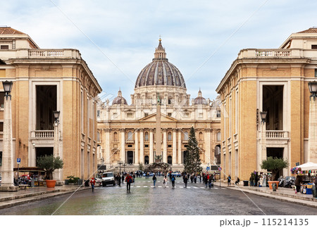 View of St. Peter's Basilica in the Vatican city against blue sky background, Rome, Italy. 115214135