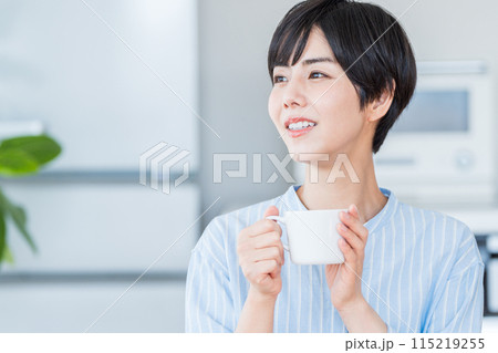 リビングでリラックスする女性。 115219255