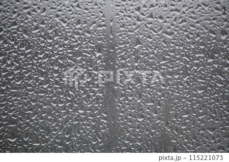Close-up view of a window covered with raindrops Close-up view of a window covered with raindrops 115221073