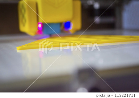 3D printer printing a model. Equipment of a 3D printer during the process of printing a model from molten plastic 3D printer printing a model. Equipment of a 3D printer during the process of printing a model from molten plastic 115221711
