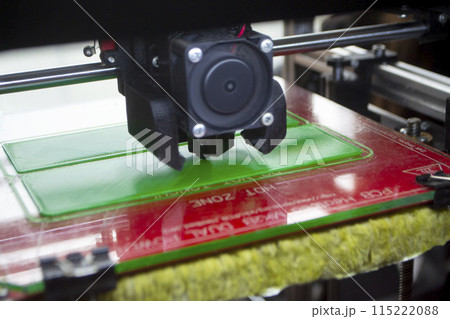 3D printer close up. Working 3D printer close-up. The process of printing on a 3D printer. 3D printer creating an object from molten plastic. 3D printer close up. Working 3D printer close-up. The process of printing on a 3D printer. 3D printer creating an object from molten plastic. 115222088
