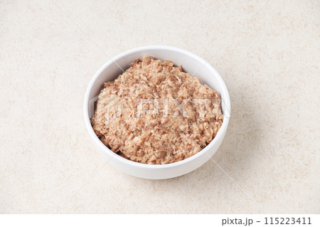 Wet cat food in a white cup on white background. 115223411