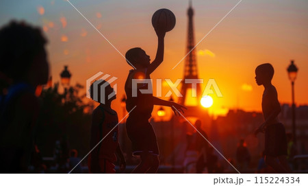 Silhouettes playing basketball with eiffel tower backdrop during sunset Silhouettes playing basketball with eiffel tower backdrop during sunset 115224334