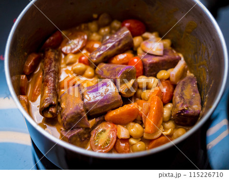 Chef at the kitchen preparing massaman curry with sweet potato and many spices 115226710