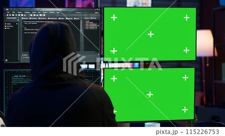Dangerous man hacking using isolated screen PC, stealing credit card information and breaching banking systems. Hacker running code in apartment on chroma key computer display, close up, camera A 115226753