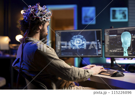 Developer with EEG headset on programming brain transfer into computer virtual world, becoming one with AI. Transhumanist using neuroscientific tech to transcend physical limitations Developer with EEG headset on programming brain transfer into computer virtual world, becoming one with AI. Transhumanist using neuroscientific tech to transcend physical limitations 115226896