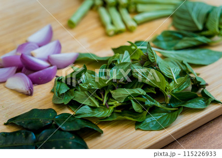 Cutting board with ingredients for preparing green curry with herbs and rice Cutting board with ingredients for preparing green curry with herbs and rice 115226933