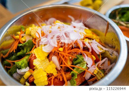 Chef at the kitchen preparing spicy glass noodle salad 115226944