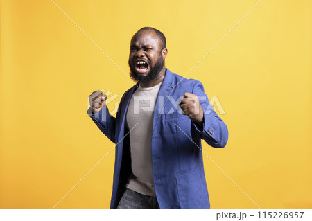Upset african american man yelling in pain from anguish after hearing painful bad news, suffering and weeping, isolated over studio background. Sad BIPOC person in distress, grieving Upset african american man yelling in pain from anguish after hearing painful bad news, suffering and weeping, isolated over studio background. Sad BIPOC person in distress, grieving 115226957