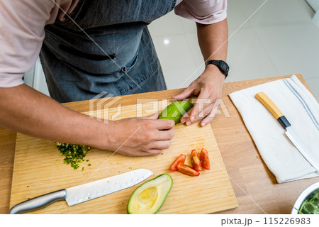 Chef at the kitchen preparing healthy quinoa bowl with avocado Chef at the kitchen preparing healthy quinoa bowl with avocado 115226983