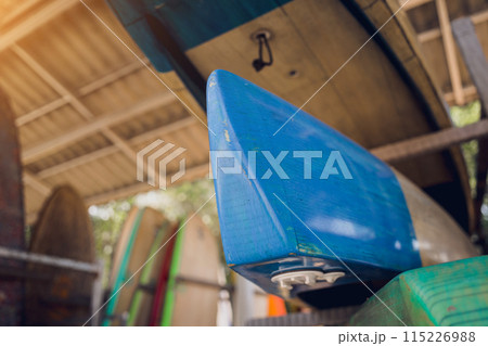 A variety of surfboards are neatly displayed on a stand A variety of surfboards are neatly displayed on a stand 115226988