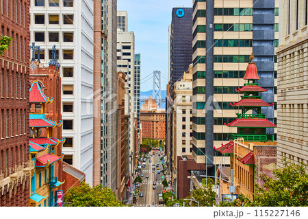 Chinatown buildings framing steep road on hill leading to Oakland Bay Bridge 115227146
