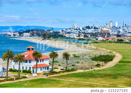 Buildings on edge of San Francisco Bay beach with sandy trail and distant San Francisco skyscrapers Buildings on edge of San Francisco Bay beach with sandy trail and distant San Francisco skyscrapers 115227193
