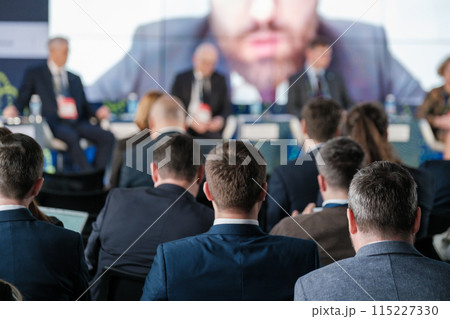 Business conference event with people listening to speakers 115227330