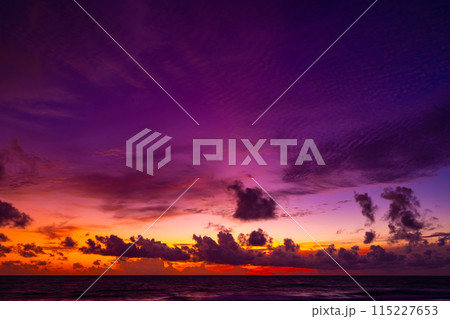 Beautiful colorful sunset or sunrise sky over sea with dramatic clouds nature environment background 115227653