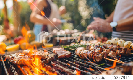 Outdoor barbecue. Focus on barbecue grill with food. Blurred background with people 115227914