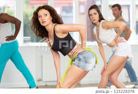 Fit and graceful woman partaking in high heels dance class 115228376