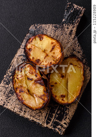 Delicious potato halves in skins baked on the grill Delicious potato halves in skins baked on the grill 115228989
