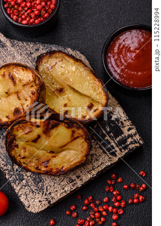 Delicious potato halves in skins baked on the grill 115228994