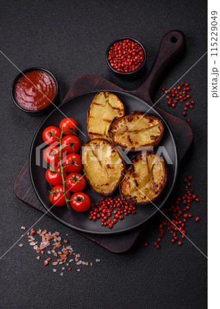 Delicious potato halves in skins baked on the grill 115229049