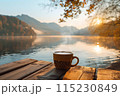 cup of hot coffee or tea with lake and mountains view on the background 115230849