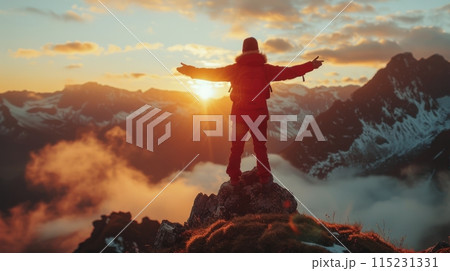Adventurer Standing on Mountain Peak at Sunset With Arms Outstretched Adventurer Standing on Mountain Peak at Sunset With Arms Outstretched 115231331