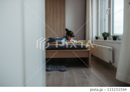 Young schoolgirl struggling with learning at home, doing homework. Learning difficulties in children 115231594