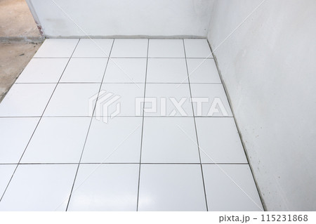 Tile floor under construction in room. 115231868