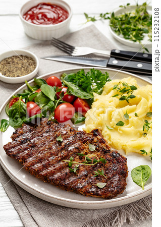 grilled pork steak with mashed potato and salad 115232108