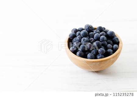 Ripe organic blueberries on white wooden table background. Selective focus. 115235278