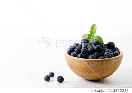 Ripe organic blueberries on white wooden table background. Selective focus. Ripe organic blueberries on white wooden table background. Selective focus. 115235285