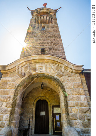 The Cerna Studnice lookout tower in the Jizera Mountains, Czechia, basking in sunlight, showcasing its impressive stone architecture. The Cerna Studnice lookout tower in the Jizera Mountains, Czechia, basking in sunlight, showcasing its impressive stone architecture. 115235381
