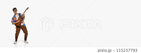 Charismatic man, talented musician playing guitar against white studio background with negative space to insert text. Charismatic man, talented musician playing guitar against white studio background with negative space to insert text. 115237793