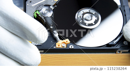 mechanic repairing hard drive, hard drive It is a device for storing data. 115238264