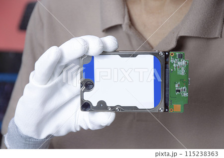 Hard disks are still popular in use today, holding a hard disk in your hand. 115238363