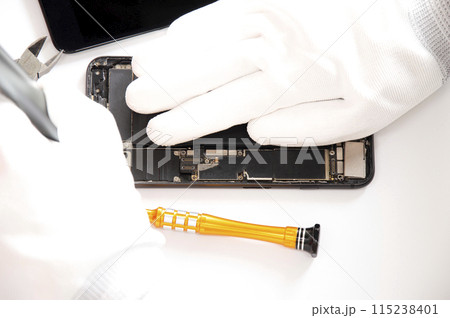 top view, technician fixing a smartphone 115238401