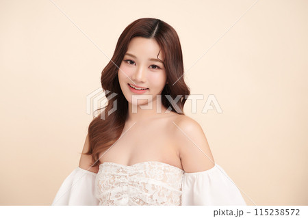 Beautiful young asian woman with clean fresh skin on beige background, Face care, Facial treatment, Cosmetology, beauty and spa, Asian women portrait. 115238572