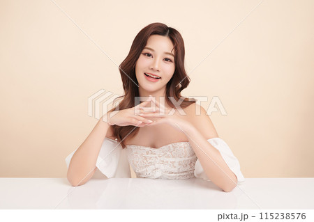 Beautiful young asian woman with clean fresh skin on beige background, Face care, Facial treatment, Cosmetology, beauty and spa, Asian women portrait. Beautiful young asian woman with clean fresh skin on beige background, Face care, Facial treatment, Cosmetology, beauty and spa, Asian women portrait. 115238576