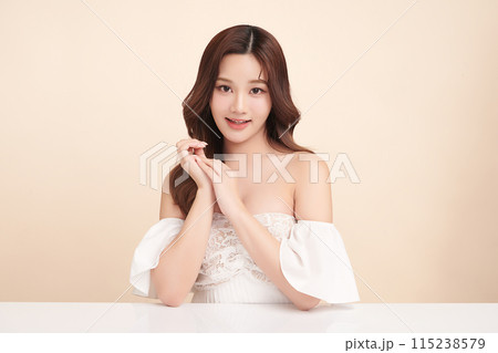Beautiful young asian woman with clean fresh skin on beige background, Face care, Facial treatment, Cosmetology, beauty and spa, Asian women portrait. Beautiful young asian woman with clean fresh skin on beige background, Face care, Facial treatment, Cosmetology, beauty and spa, Asian women portrait. 115238579