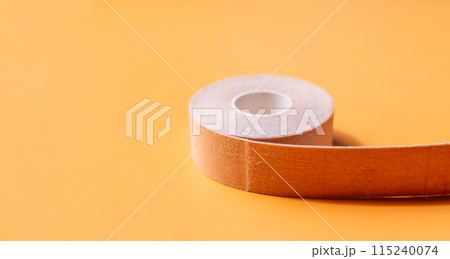 Adhesive tapes for the face in rolls on a yellow background 115240074