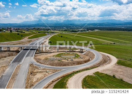 Drone shot of the highway construction from Krakow to Zakopane in the summer. Drone shot of the highway construction from Krakow to Zakopane in the summer. 115241424